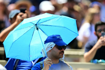 Several people used parasols to attend Pope Leo XIV's address at St Peter's square in the Vatican on Sunday - Tiziana FABI (AFP)