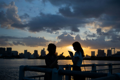 A Japanese city will urge all smartphone users to limit screen time to two hours a day outside work or school under a draft ordinance that includes no penalties - Martin BUREAU (AFP)