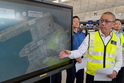 Steven Yiu, Airport Authority Hong Kong's executive director of operations, briefs reporters after a plan skidded off the tarmac - Holmes CHAN (AFP)
