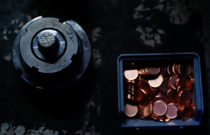 The dies used to press the last pennies along with the planchets, or blank disks that will become coins, at the US Mint - Matthew Hatcher (AFP)