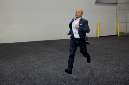 A visitor at CES tries out an exoskeleton from Dnsys - Caroline Brehman (AFP)