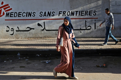 Palestinians walk past the MSF clinic in Gaza City's al-Rimal neighbourhood - Omar AL-QATTAA (AFP)